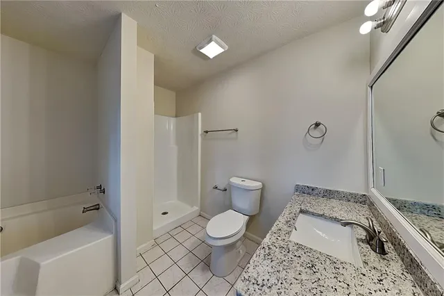 a bathroom with a toilet sink and shower
