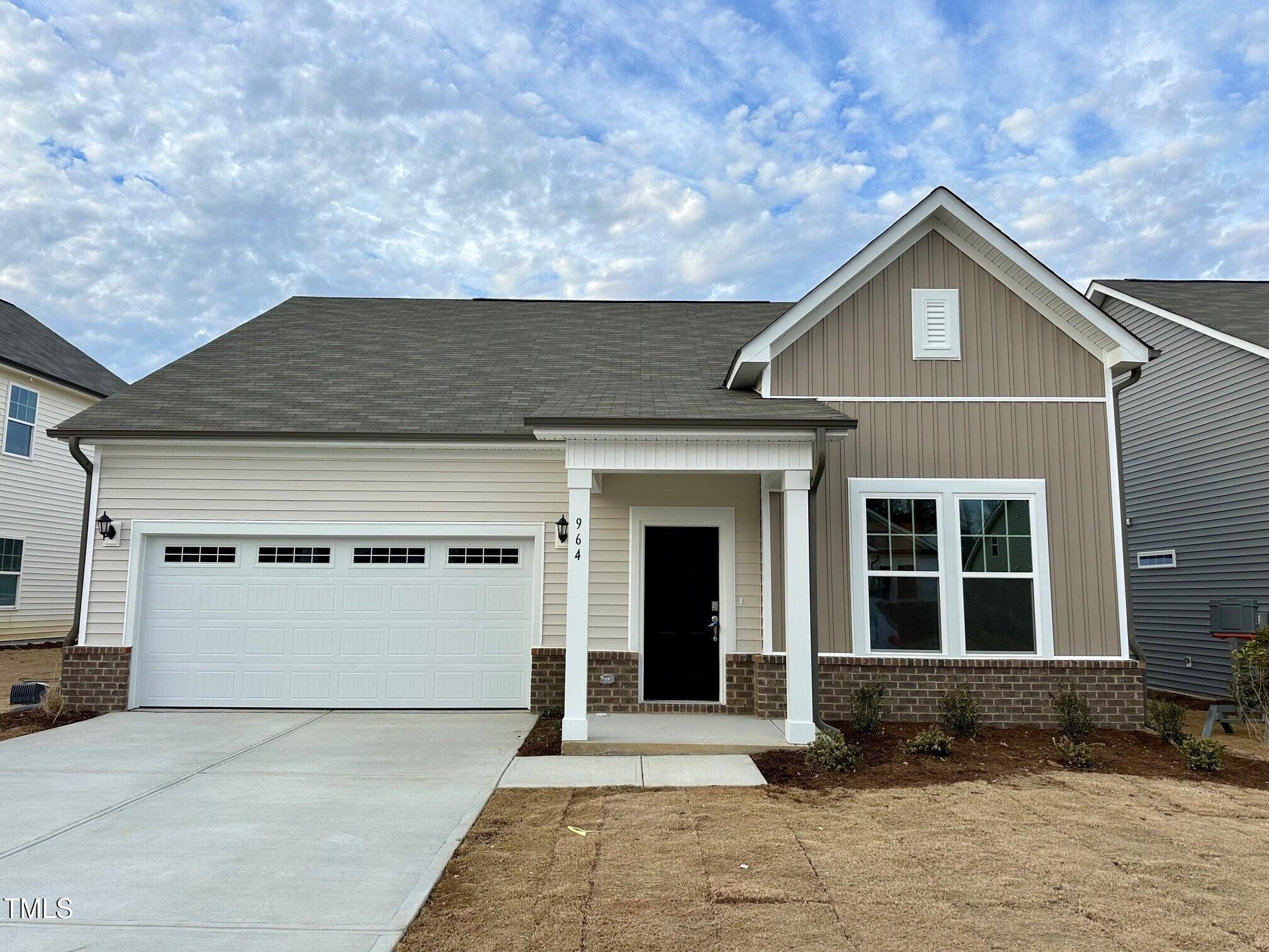 964 Channel Drop Loop Zebulon, NC 27597 - Photo 1 of 30 a front view of a house with a garage and a yard