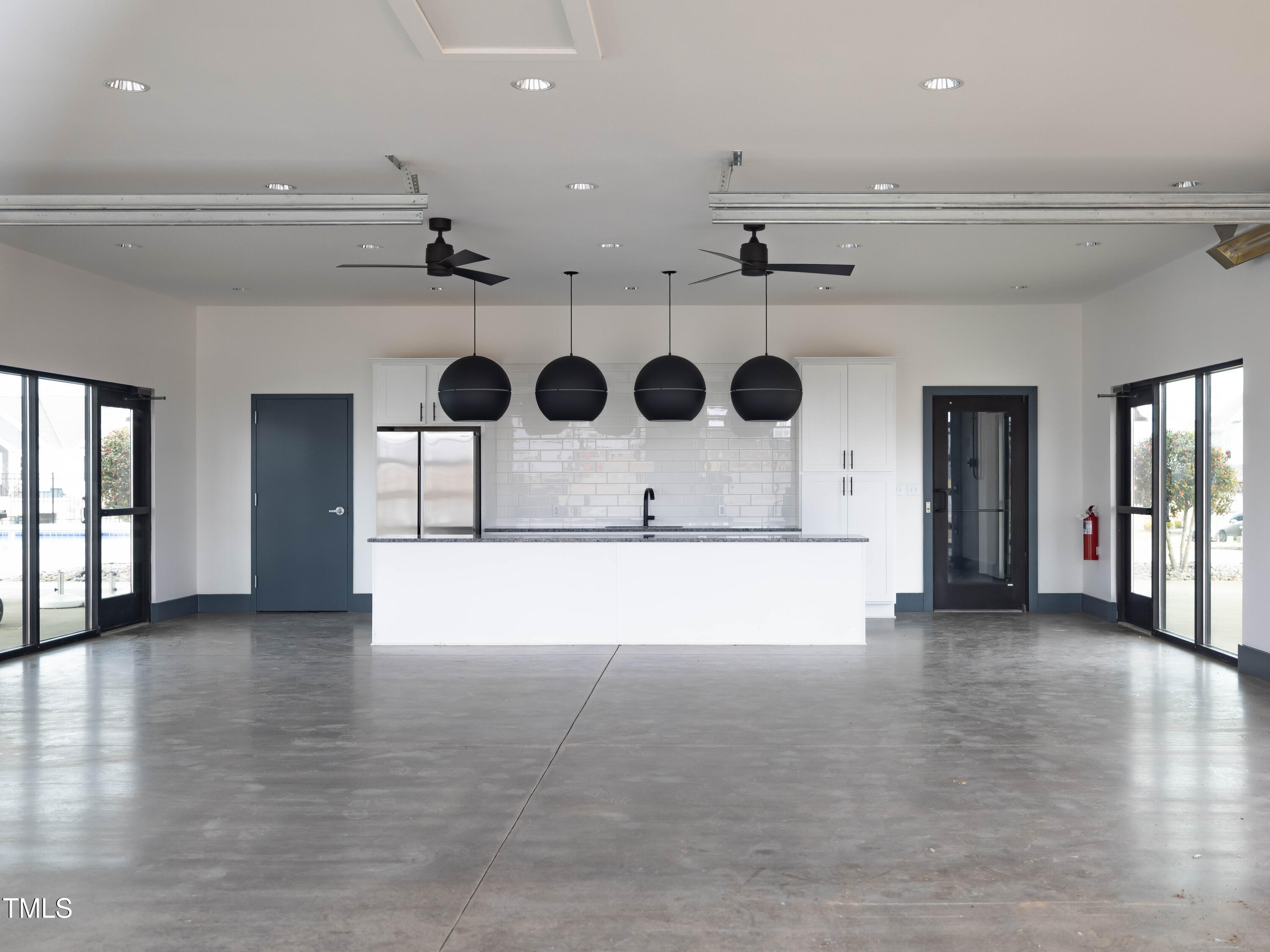 964 Channel Drop Loop Zebulon, NC 27597 - Photo 25 of 30 a view of an empty room with wooden floor and windows