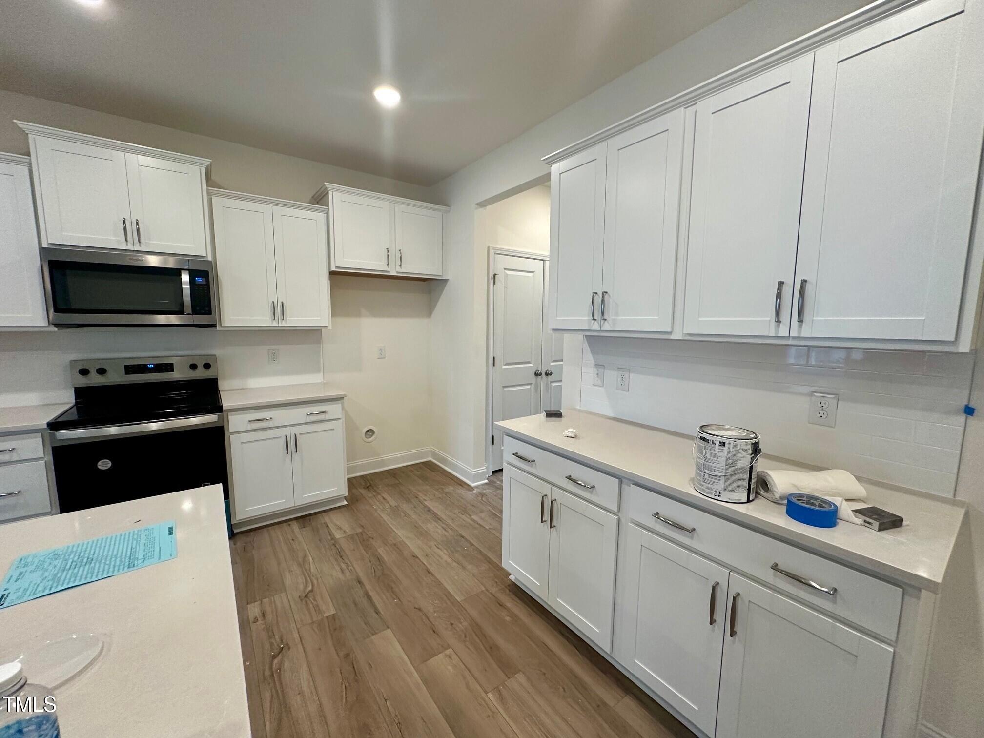 964 Channel Drop Loop Zebulon, NC 27597 - Photo 4 of 30 a kitchen with a sink a stove and cabinets