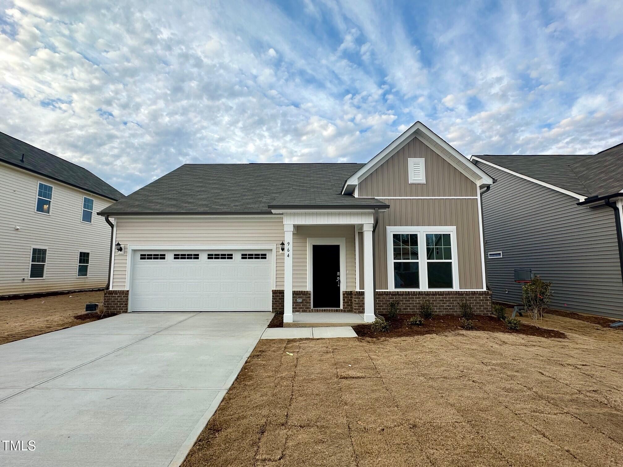 964 Channel Drop Loop Zebulon, NC 27597 - Photo 10 of 30 a front view of a house with a yard and garage