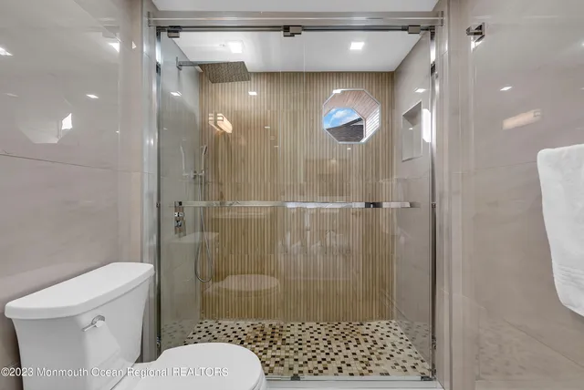 a bathroom with a shower and a toilet