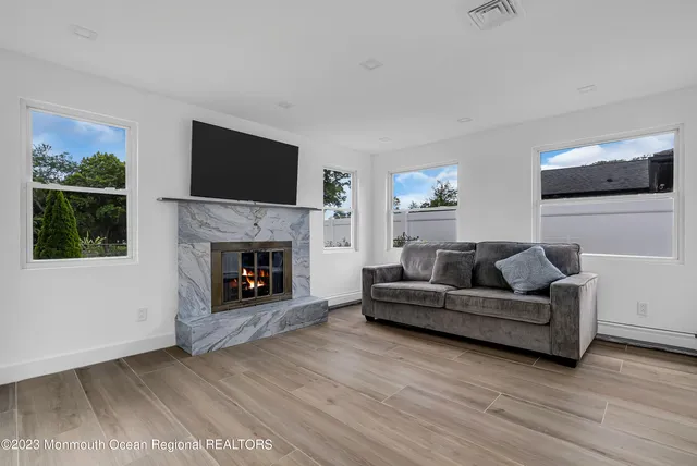a living room with furniture and a fireplace