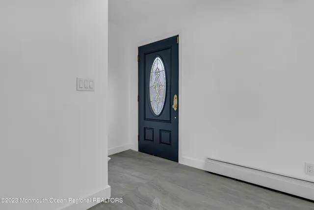 a view of front door with a mirror