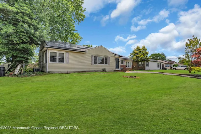 a front view of house with yard and green space