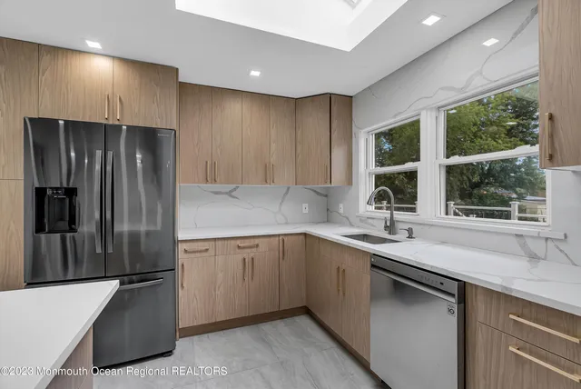 a kitchen with a sink and a refrigerator