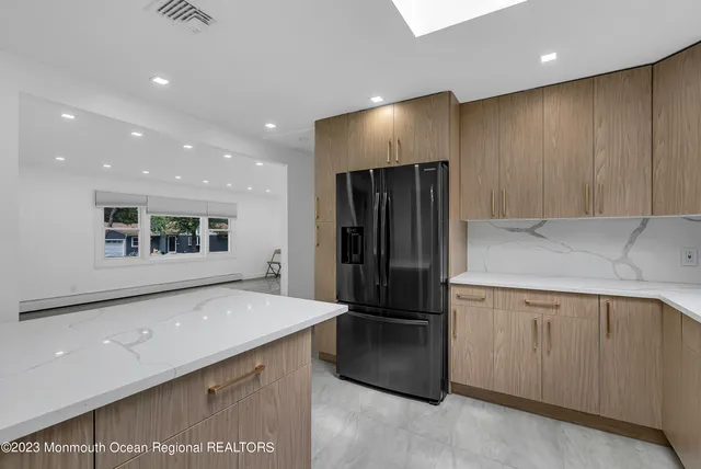 a kitchen with stainless steel appliances a refrigerator and a microwave