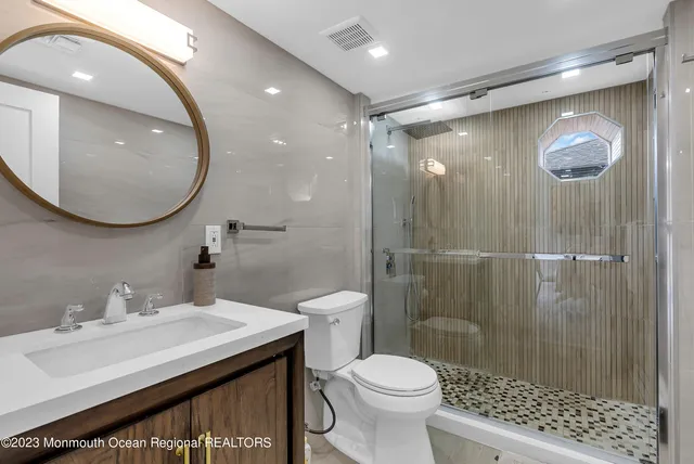 a bathroom with a sink toilet and shower