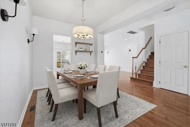 a view of a dining room with furniture wooden floor and chandelier