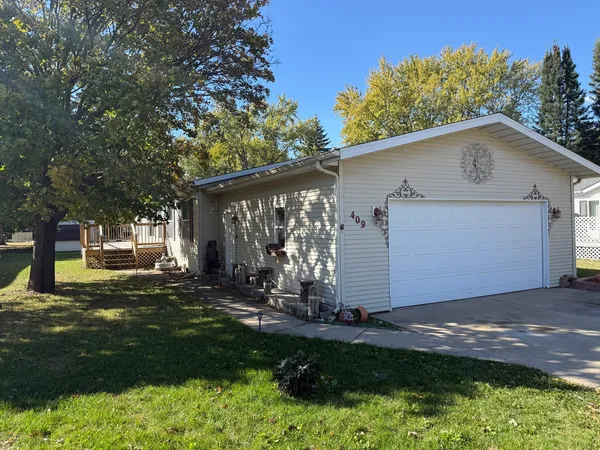 a view of a house with yard and tree s