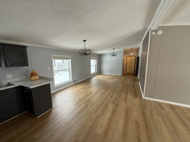 a view of a livingroom with wooden floor and a window