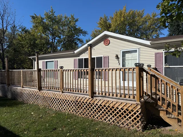 a view of a white house with a deck