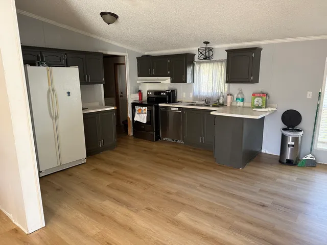 a kitchen with stainless steel appliances a refrigerator and microwave