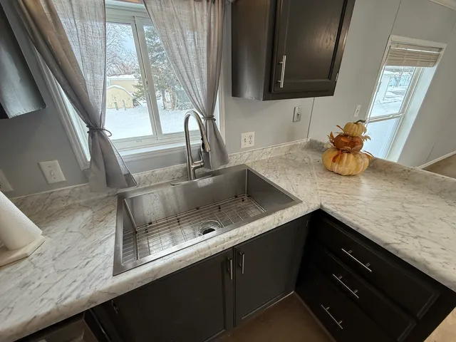 a kitchen with sink and a window