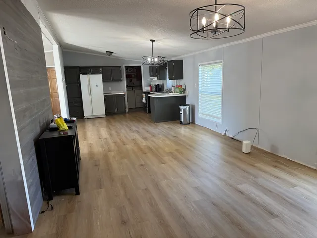 a view of a room with a flat screen tv and fireplace