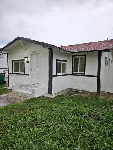 a front view of a house with yard
