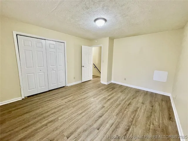 a view of an empty room and wooden floor