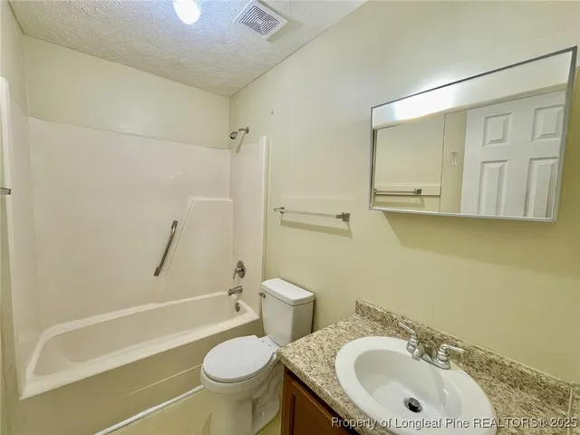 a bathroom with a sink a toilet and a bathtub