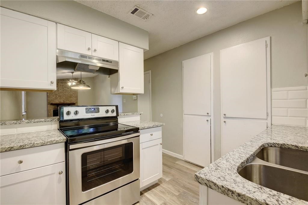 2311 Teri Road, Unit B Austin, TX 78744 - Photo 10 of 25 a kitchen with stainless steel appliances granite countertop a sink stove and cabinets