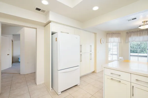 a view of kitchen with refrigerator and window
