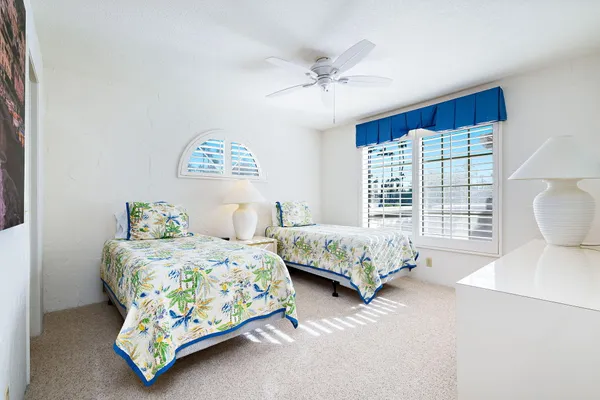 a bedroom with a bed mirror and window