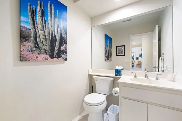 a bathroom with a toilet sink and vanity
