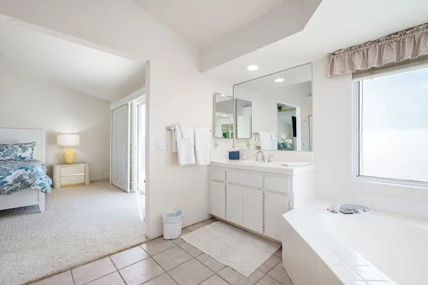a bathroom with a sink vanity and a mirror