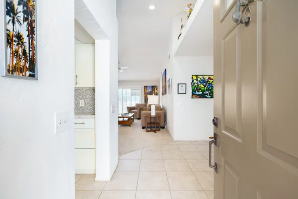 a view of hallway with livingroom and furniture