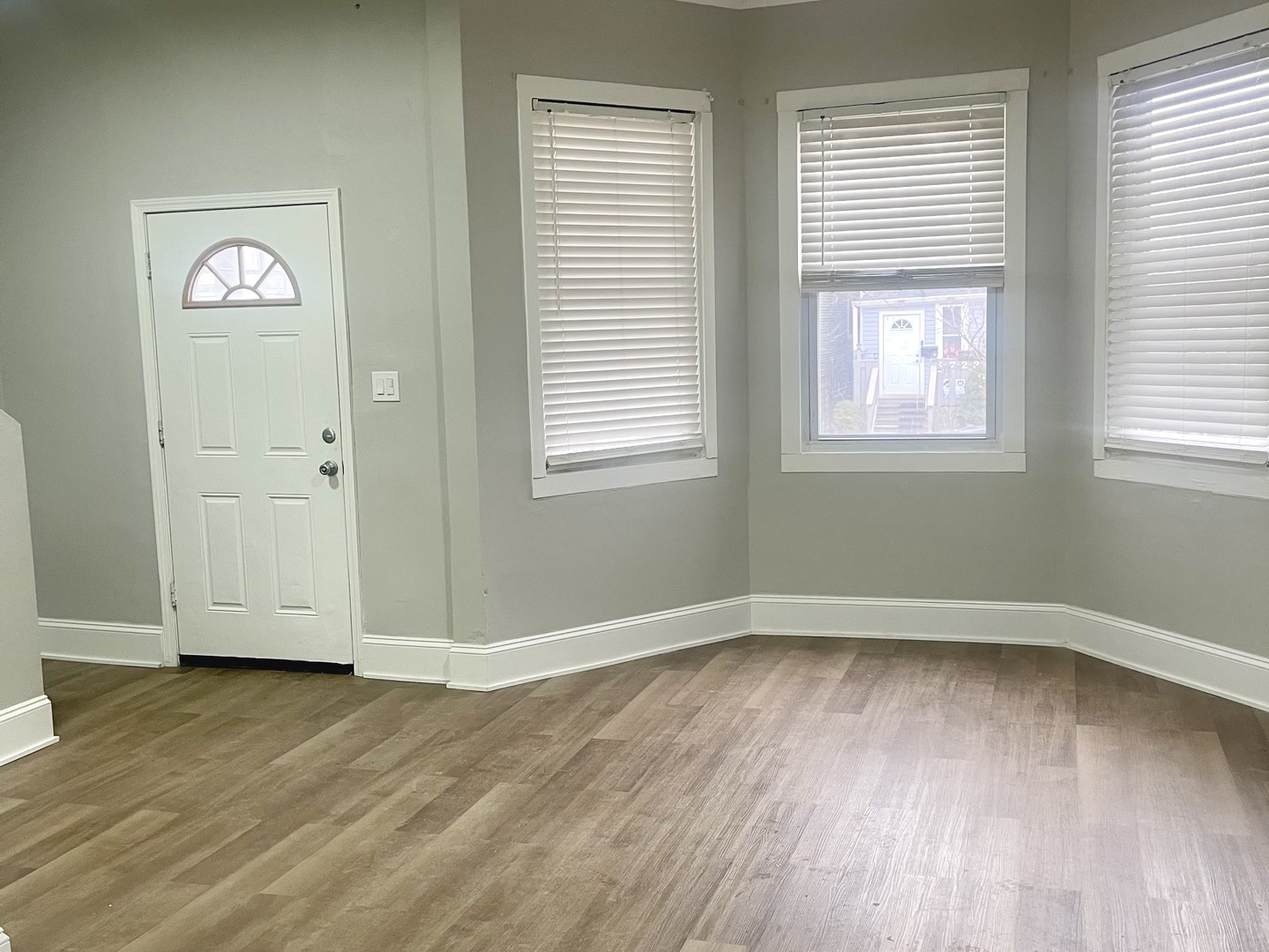 1722 North Keeler Avenue Chicago, IL 60639 - Photo 3 of 3 an empty room with wooden floor and windows