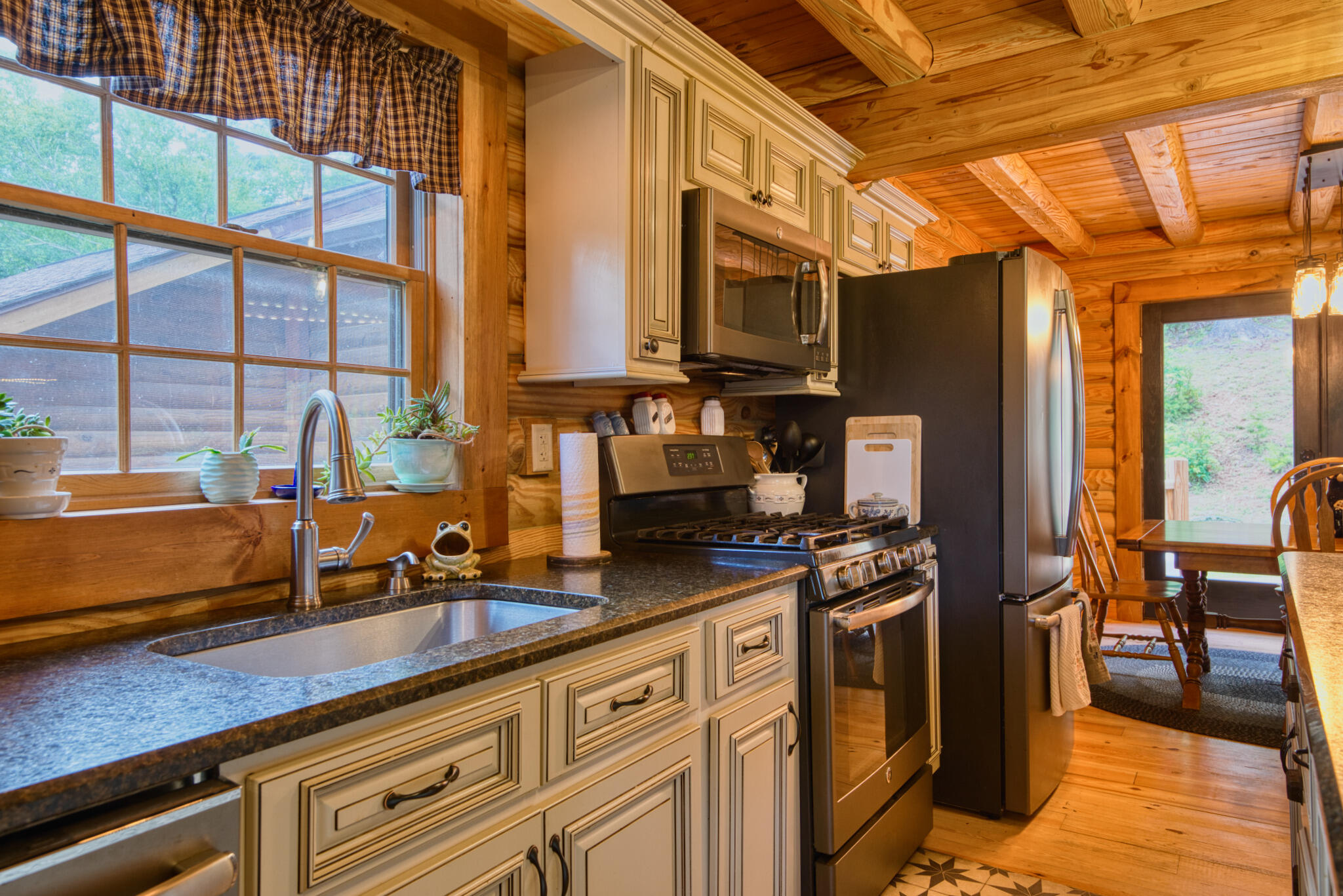 567 Weeks Road Northwest Floyd, VA 24091 - Photo 33 of 71 a kitchen with stainless steel appliances granite countertop a stove a sink and a microwave