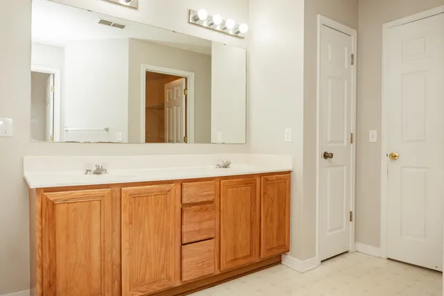 a bathroom with a sink a mirror and a shower