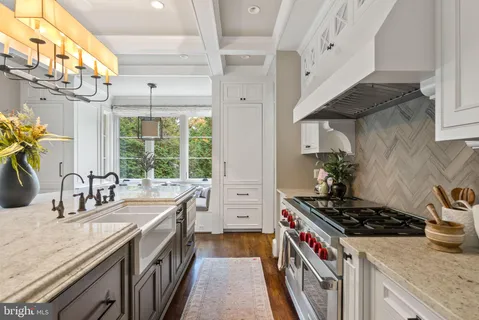 a open kitchen with stainless steel appliances granite countertop a stove and a view of living room