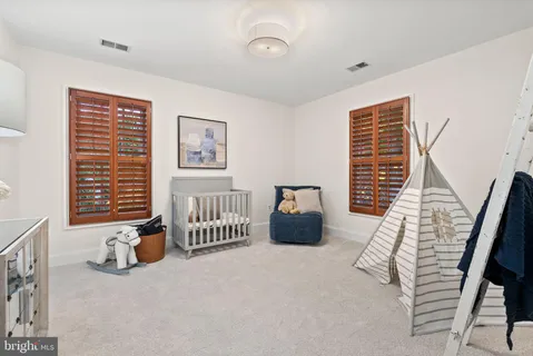 a living room with furniture a fireplace and a large window