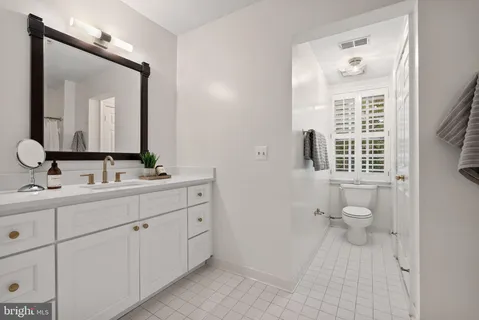 a bedroom with a bed and a view of living room