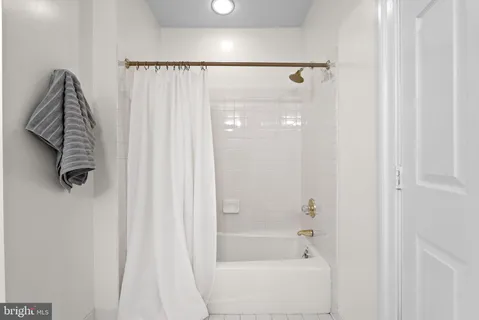 a view of a room with wooden floor and windows
