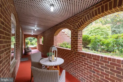 a kitchen with white cabinets and wooden floor