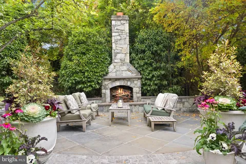 a kitchen with a stove a chandelier and a large window