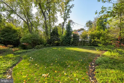 a spacious bedroom with a bed and a chandelier