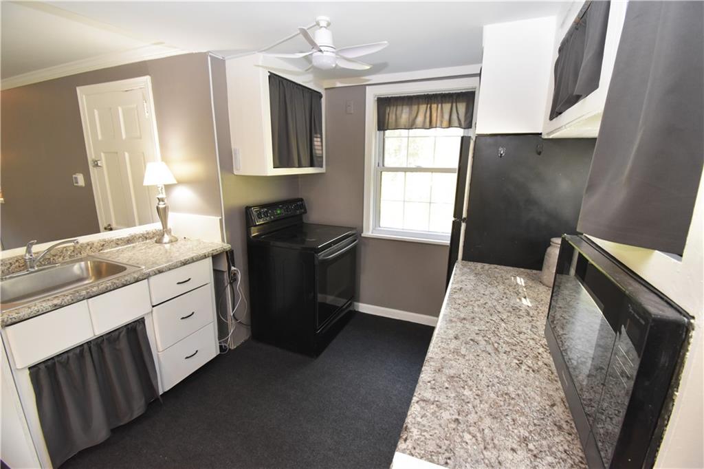 223 Nantucket Drive Pittsburgh, PA 15236 - Photo 7 of 25 a kitchen with granite countertop a sink stove and refrigerator