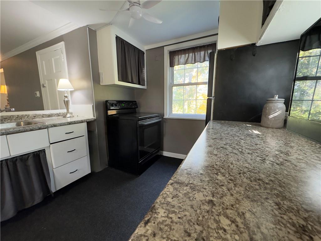 223 Nantucket Drive Pittsburgh, PA 15236 - Photo 8 of 25 a kitchen with a stove a sink and a window