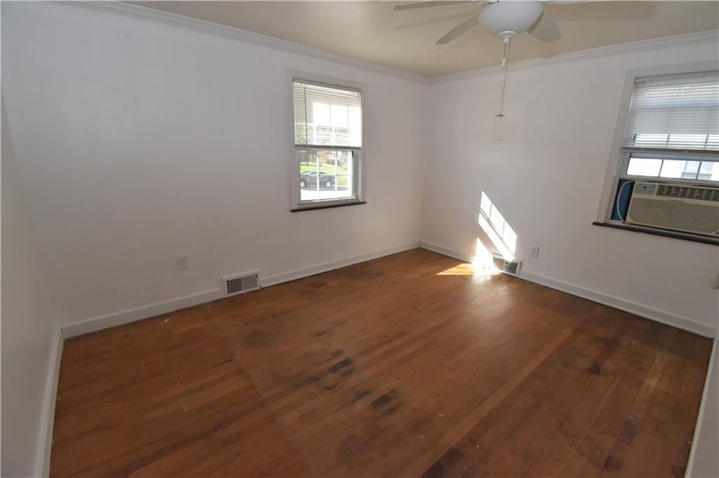 223 Nantucket Drive Pittsburgh, PA 15236 - Photo 9 of 25 an empty room with wooden floor and windows