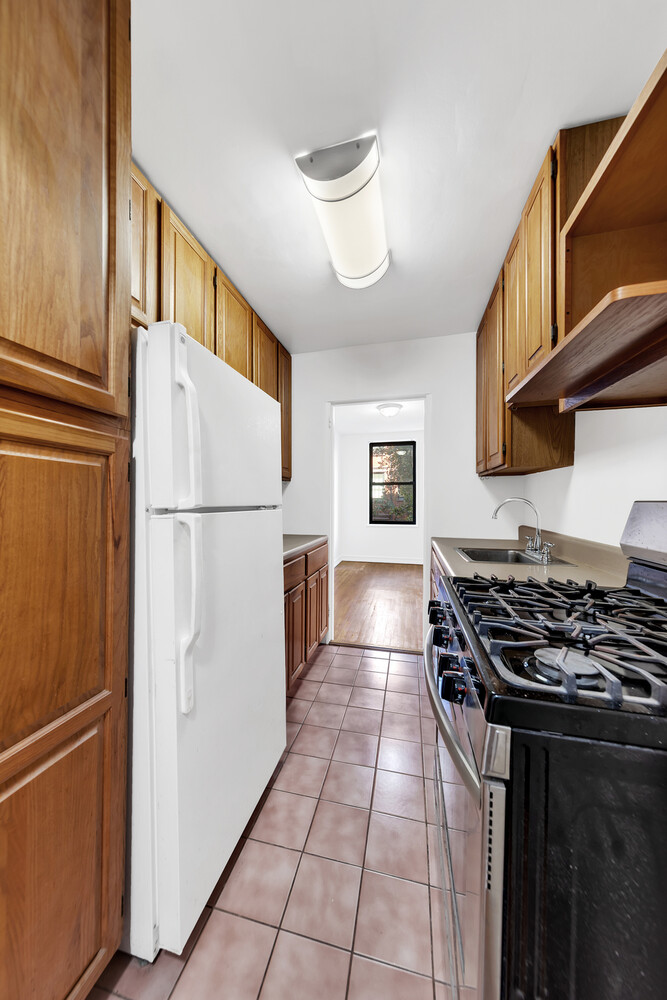 100 Bank Street, Unit 2B Manhattan, NY 10014 - Photo 4 of 9 a kitchen with a refrigerator a stove and a sink