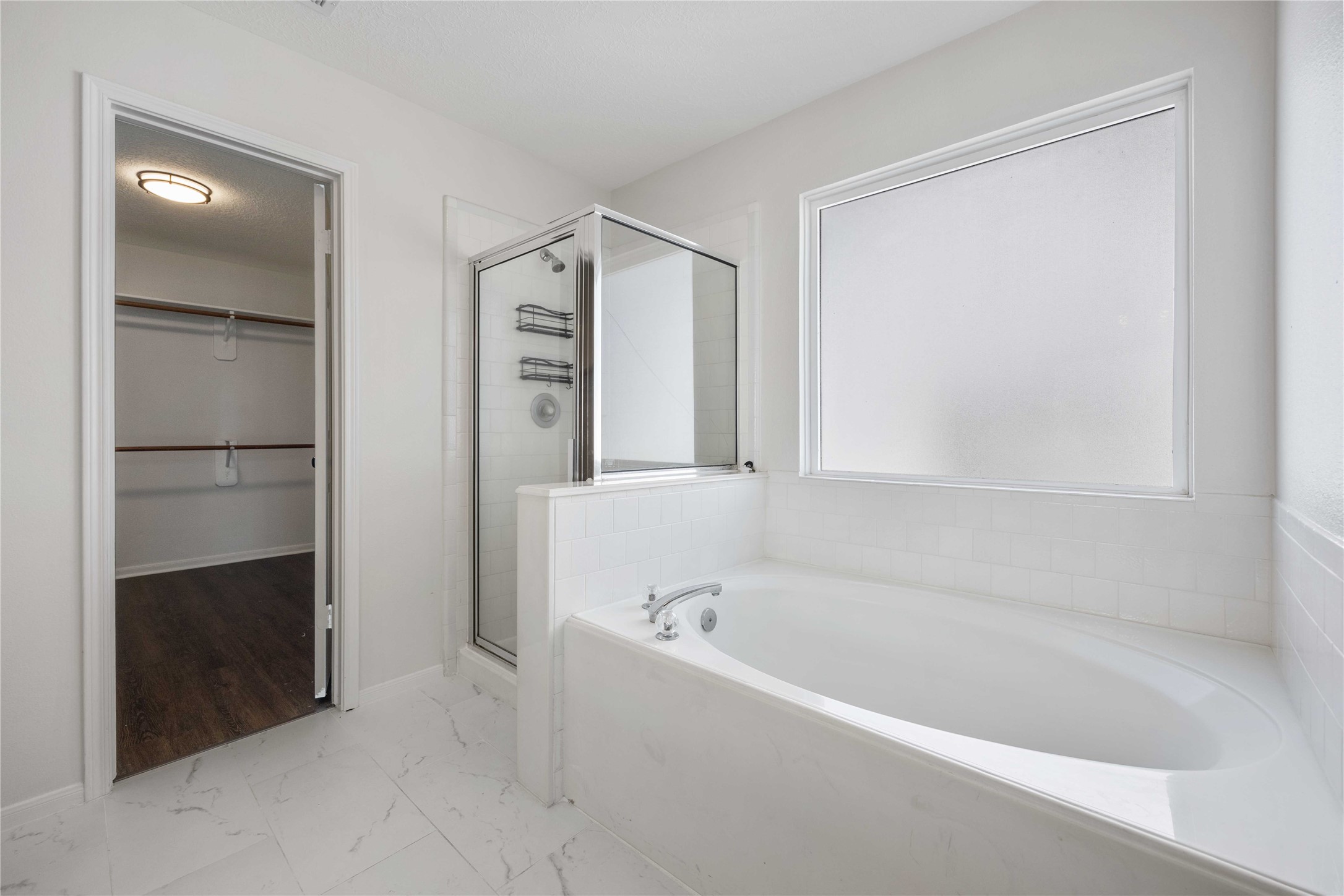 12714 Sandri Lane Houston, TX 77077 - Photo 20 of 28 a white bath tub sitting in a en suite bathroom