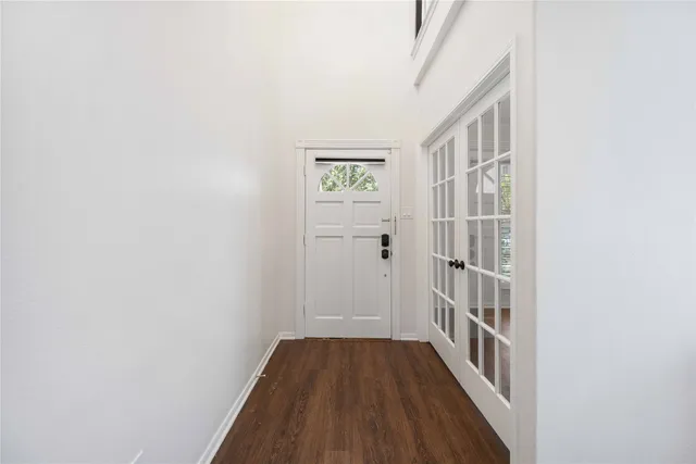 a view of a hallway with wooden floor and entryway