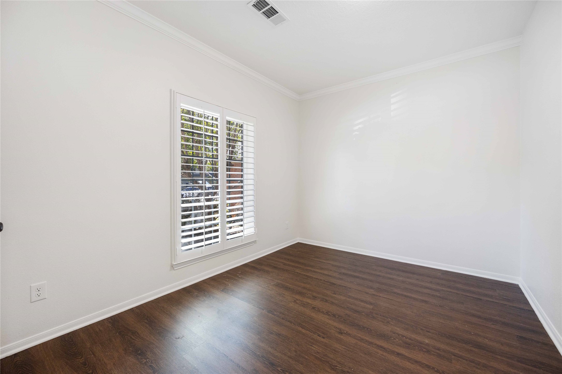 12714 Sandri Lane Houston, TX 77077 - Photo 3 of 28 an empty room with wooden floor and windows