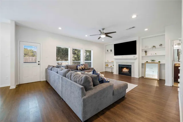 a living room with furniture a fireplace and a flat screen tv