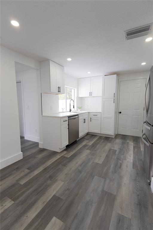 6340 Westport Drive Port Richey, FL 34668 - Photo 15 of 51 a view of a kitchen with wooden floor
