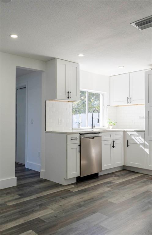 6340 Westport Drive Port Richey, FL 34668 - Photo 17 of 51 a kitchen with granite countertop white cabinets and white appliances