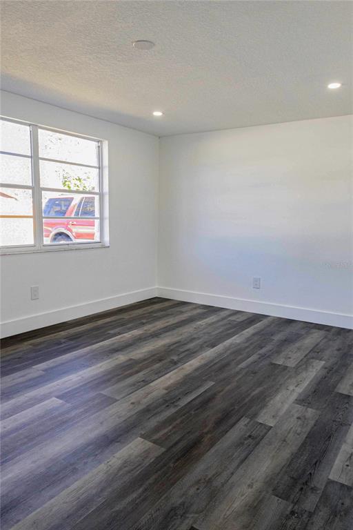 6340 Westport Drive Port Richey, FL 34668 - Photo 28 of 51 an empty room with wooden floor and window