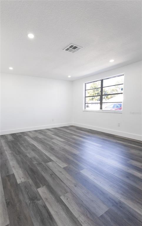 6340 Westport Drive Port Richey, FL 34668 - Photo 29 of 51 an empty room with wooden floor and windows